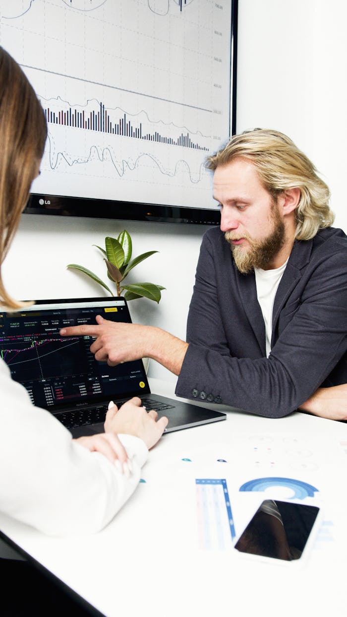 Home Professionals discussing financial charts and graphs during a business meeting.