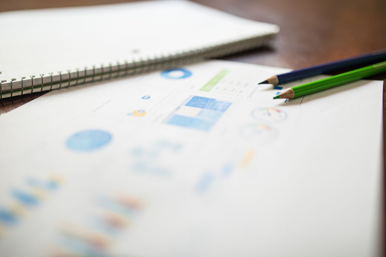 Close-up of colored pencils on an analytics report for education or business purposes.